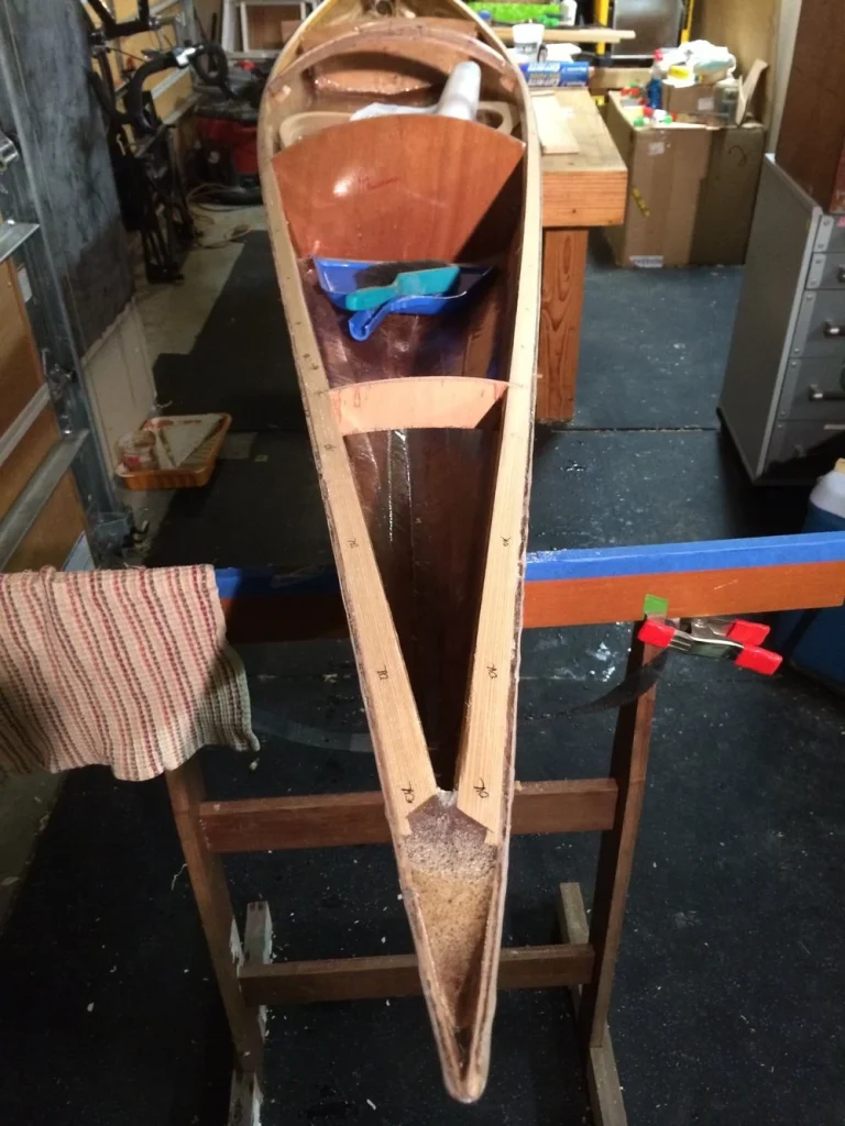 process of making kayak in wood shop