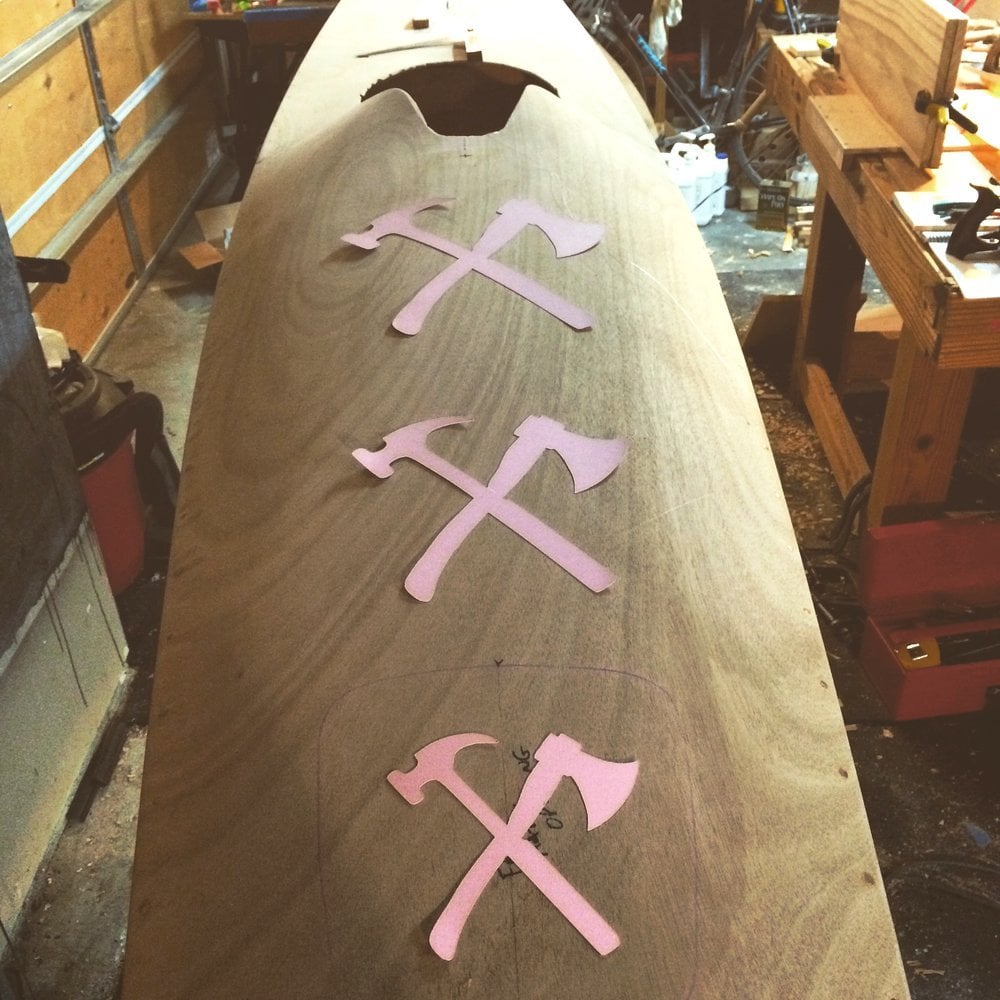 hammer and hatchet stencil on wooden kayak