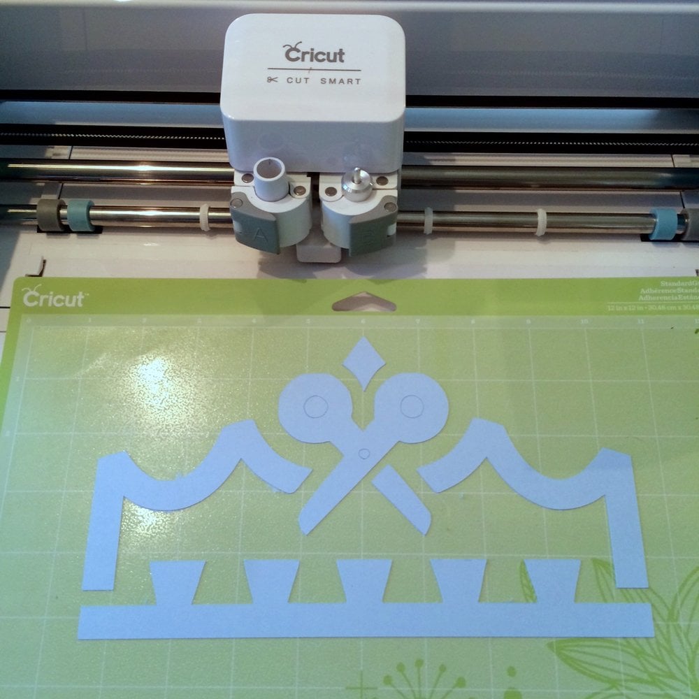 close up of cricut machine cutting out Kingston Crafts logo