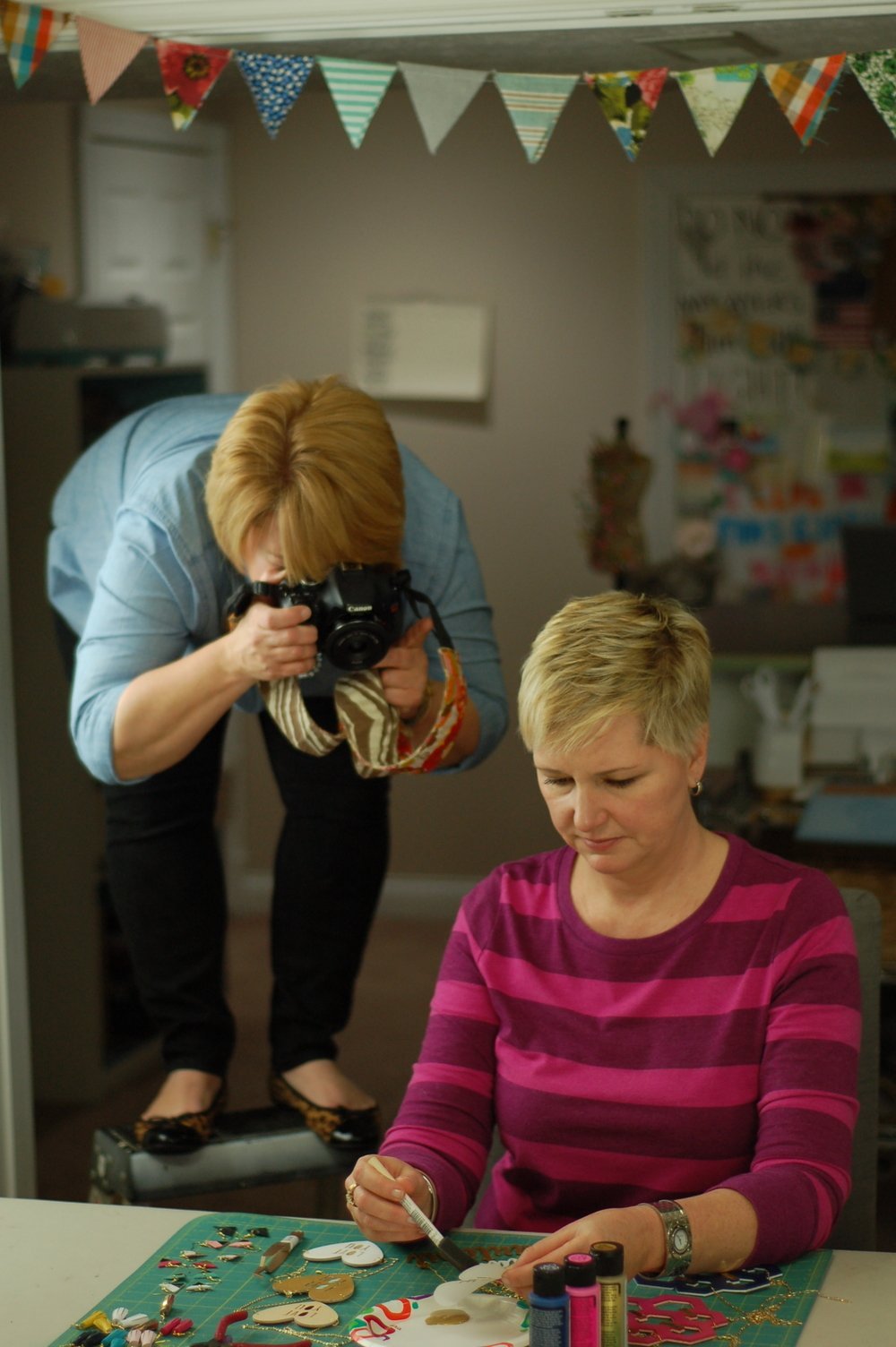 woman taking picture of Beth Kingston making cricut necklaces 