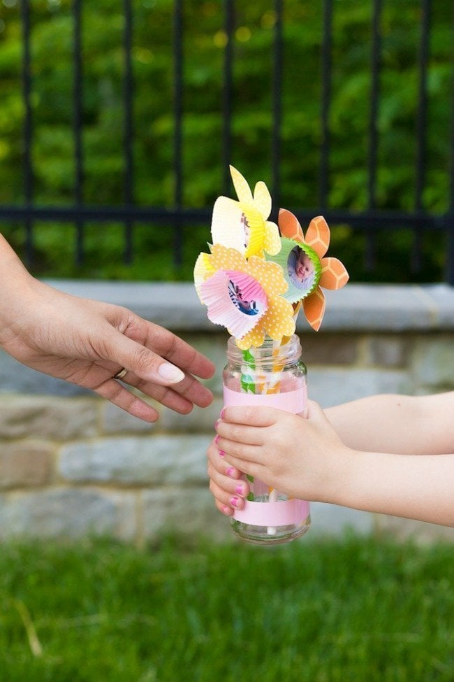 child giving mother paper flowers