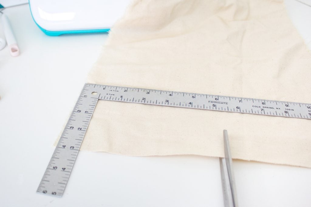 measuring and cutting fabric for Happy Easter Banner