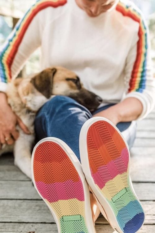 Beth with dog and rainbow shoes