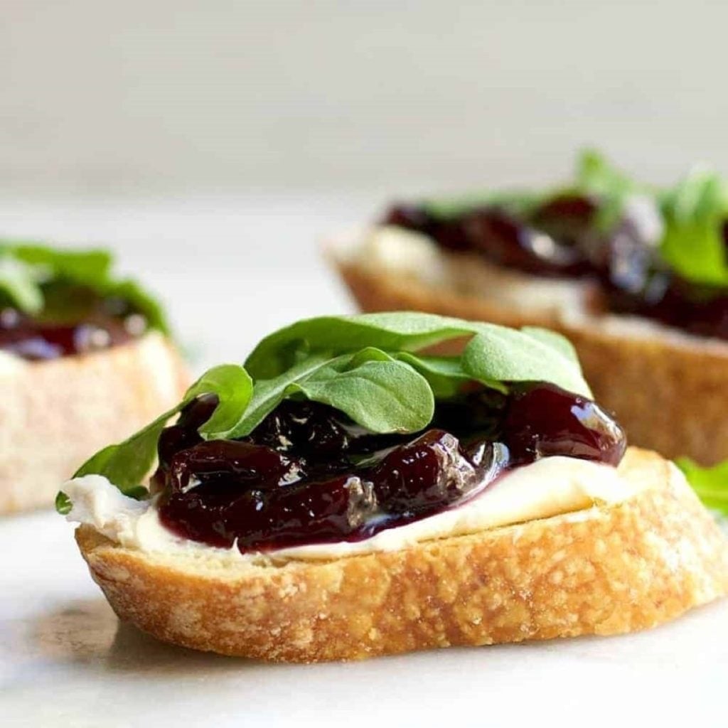 Brie Crostini With Cherries And Arugula by Pinch And Swirl